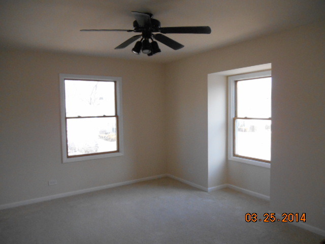 9 Edgewood Road Vernon Hills, IL 60061 - Photo 8 of 13 an empty room with a window and a fan