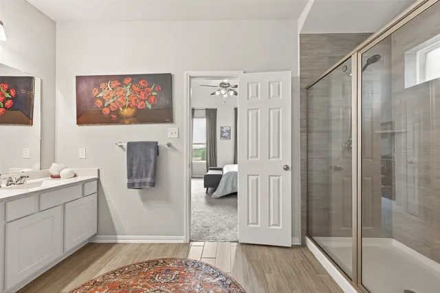 a view of a bathroom with sink mirror and window