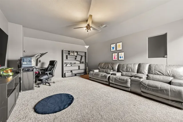 a view of a room with furniture and a window