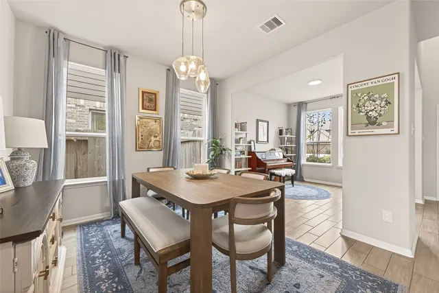 a view of a dining room with furniture and window