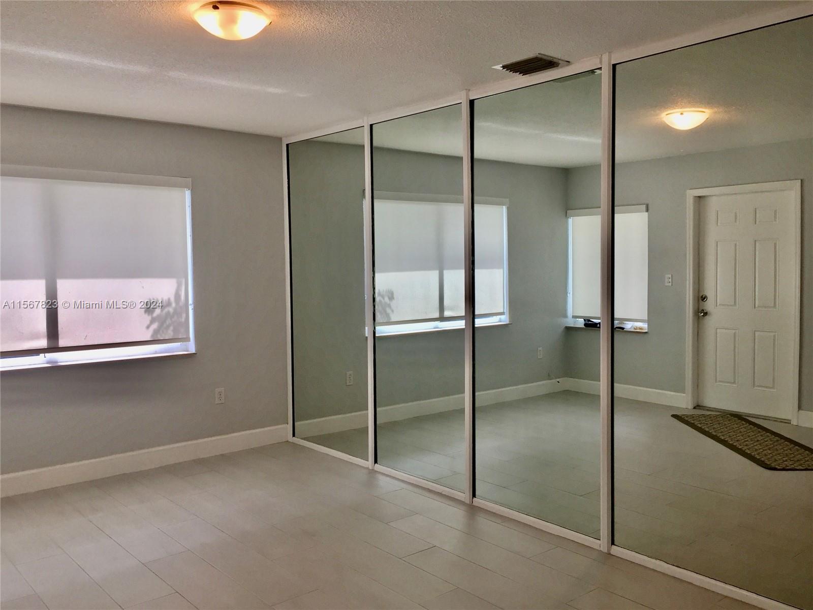 2862 Southwest 32nd Avenue Miami, FL 33133 - Photo 3 of 8 a bathroom with a glass shower door