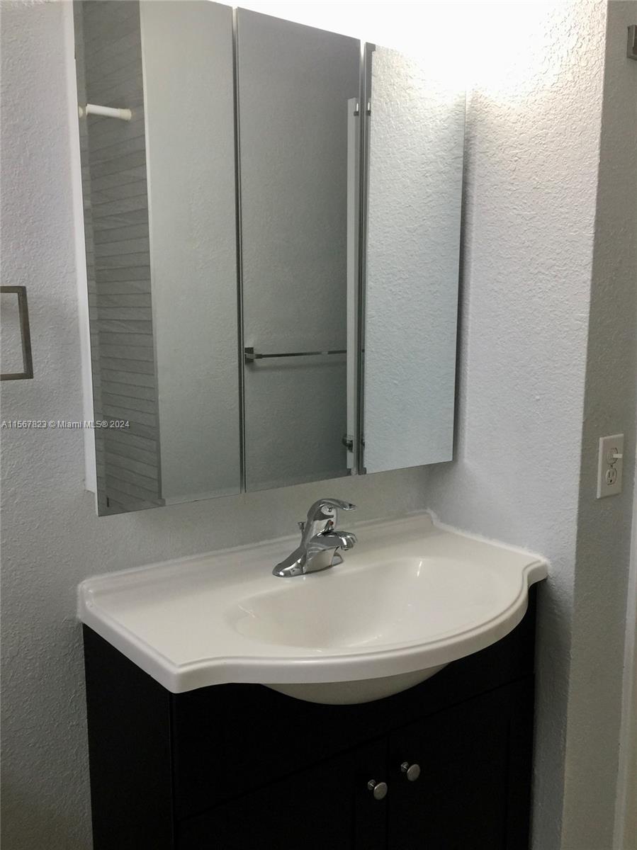 2862 Southwest 32nd Avenue Miami, FL 33133 - Photo 6 of 8 a bathroom with a sink and a mirror
