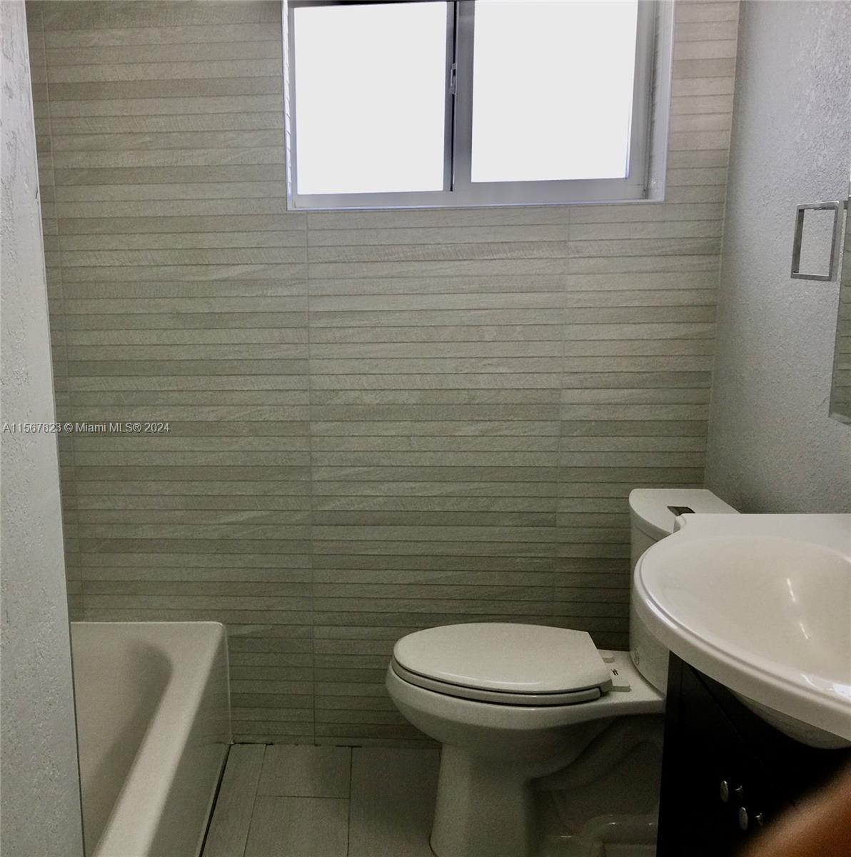 2862 Southwest 32nd Avenue Miami, FL 33133 - Photo 8 of 8 a bathroom with a toilet a sink and mirror