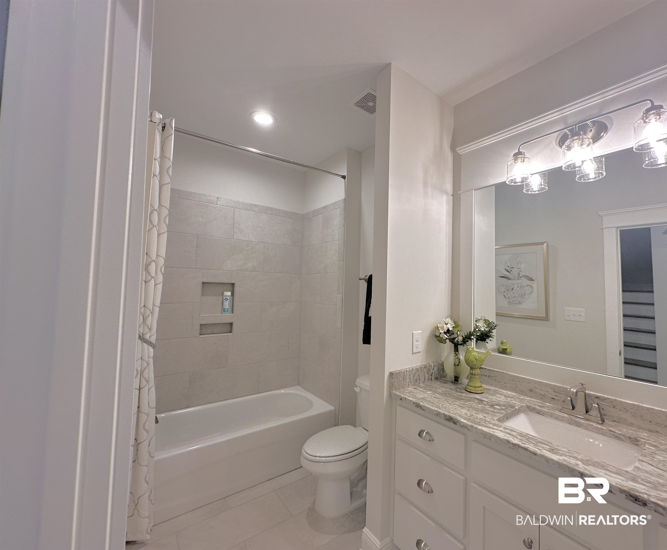 691 Kitfox Avenue Fairhope, AL 36532 - Photo 21 of 42 Full bathroom with vanity, tile patterned flooring, toilet, and shower / bath combo with shower curtain