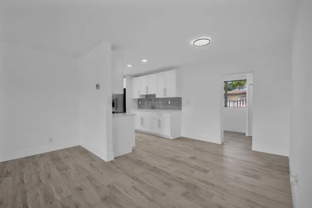 a view of kitchen with wooden floor and electronic appliances