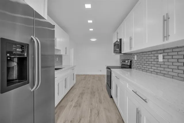 a view of empty room with wooden floor