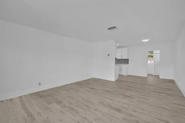 an empty room with windows and painted walls