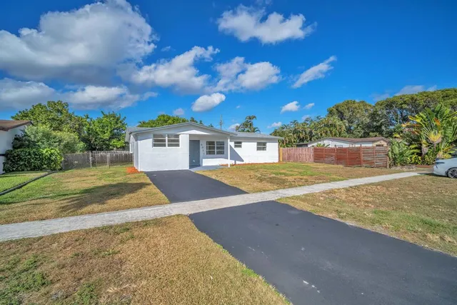 a view of backyard of house with green space