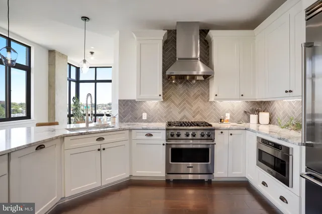 a kitchen with granite countertop a stove and a sink