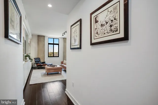 a living room with furniture and kitchen view