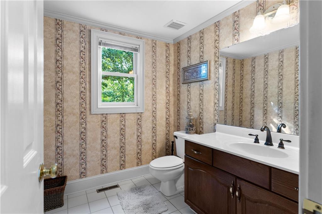 24 Commerce Row Northeast Cartersville, GA 30121 - Photo 15 of 37 a bathroom with a sink a toilet and a large mirror