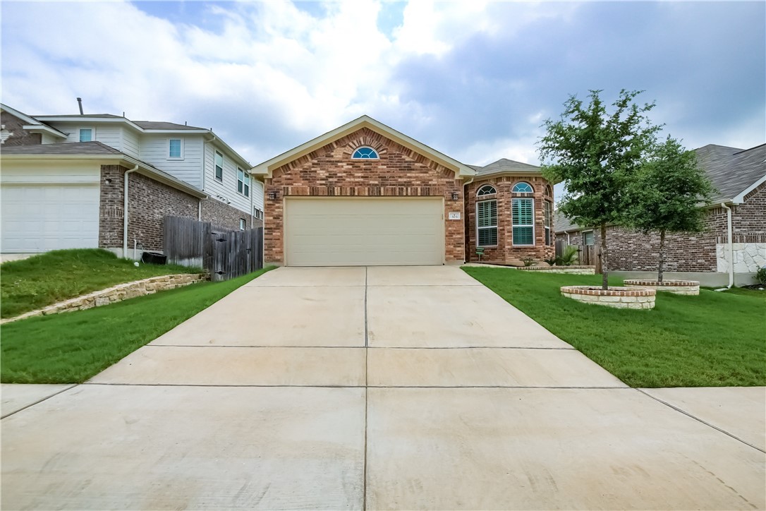303 Everglade Drive Buda, TX 78610 - Photo 1 of 1 a view of a house with a yard and potted plants