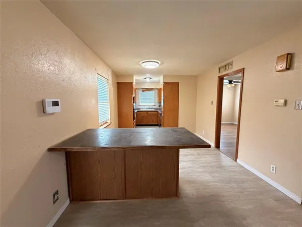 a view of a hallway with furniture