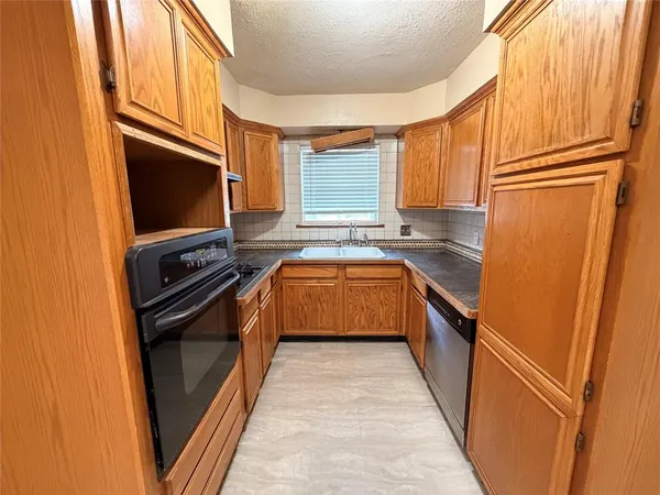 a kitchen with a sink stove and refrigerator