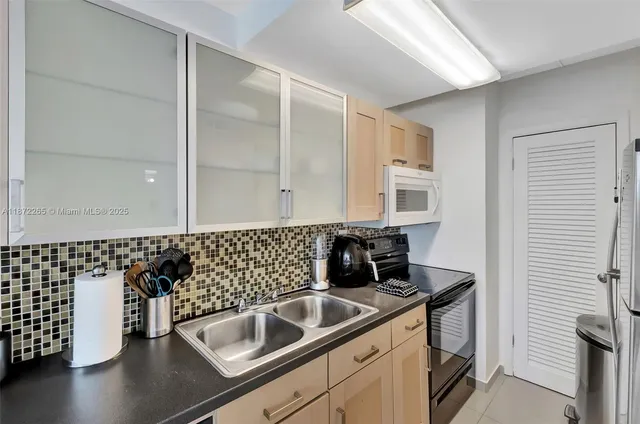 a kitchen with a sink and cabinets