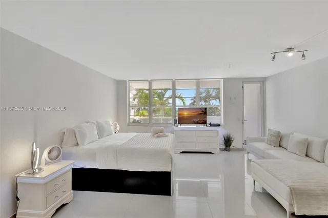 a bedroom with furniture and a wooden floor