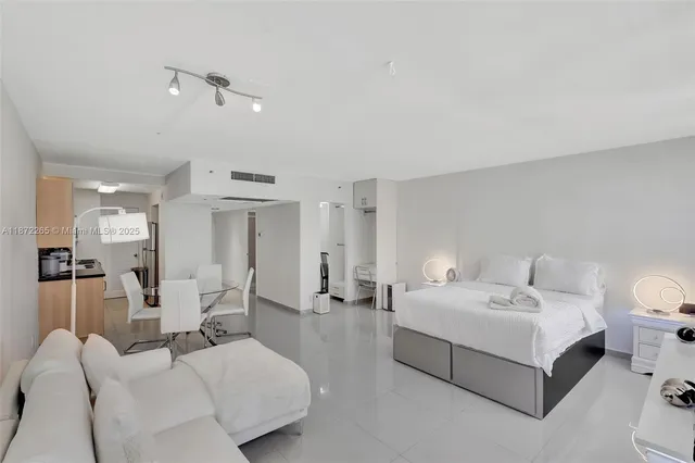 a bedroom with a bed and glass window