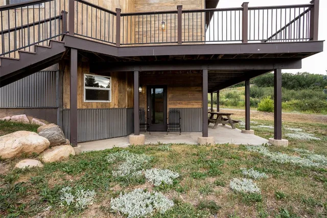 a view of a porch with furniture and floor to ceiling window