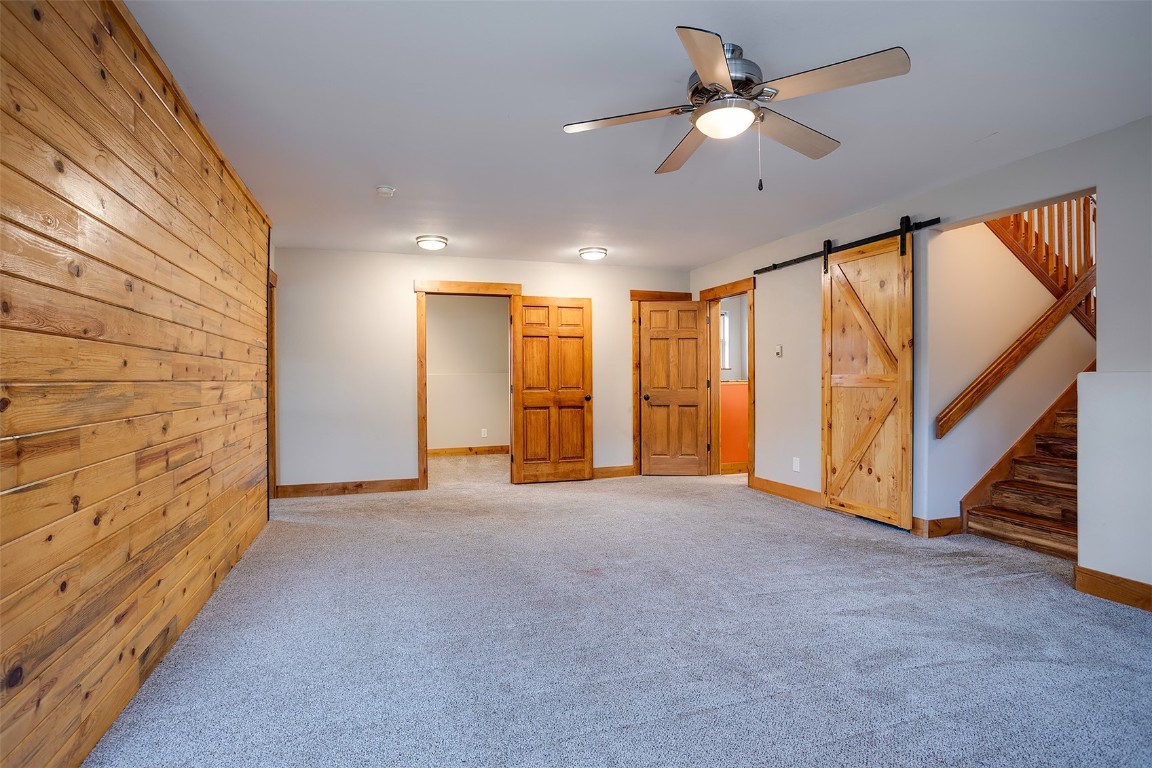 1170 Fish Creek Falls Road Steamboat Springs, CO 80487 - Photo 19 of 24 a view of an empty room with a ceiling fan and window