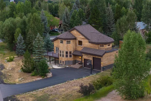 an aerial view of a house with swimming pool and garden