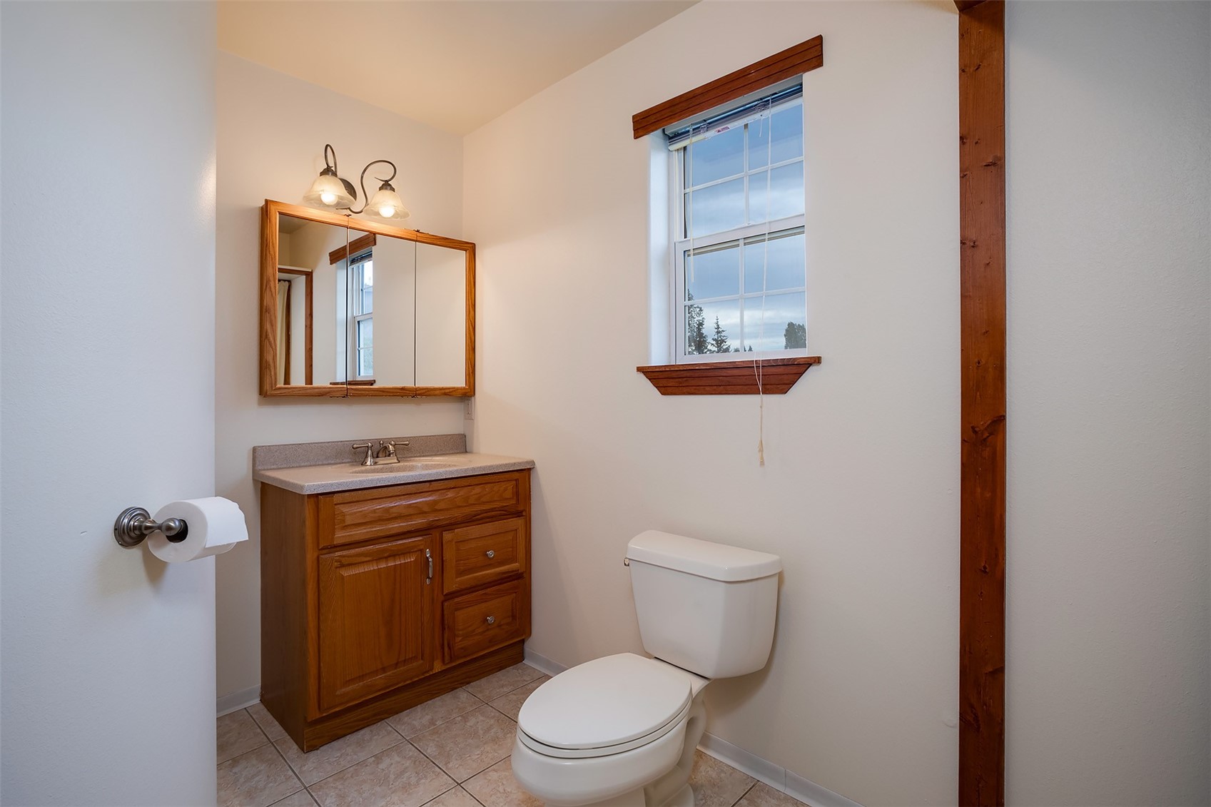 1170 Fish Creek Falls Road Steamboat Springs, CO 80487 - Photo 6 of 24 a bathroom with a toilet a sink and mirror