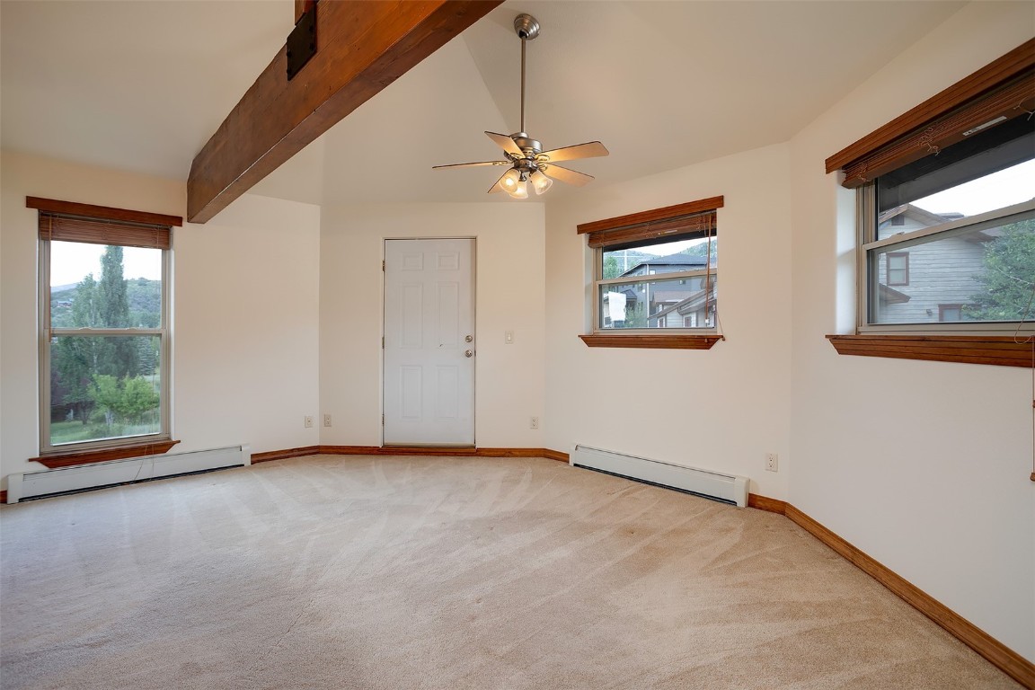 1170 Fish Creek Falls Road Steamboat Springs, CO 80487 - Photo 10 of 24 an empty room with windows and ceiling fan
