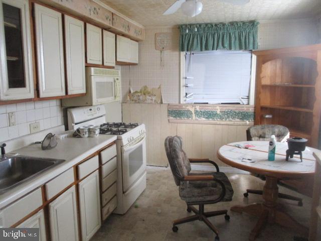 9612 Convent Avenue Philadelphia, PA 19114 - Photo 5 of 33 a kitchen with a sink cabinets and window