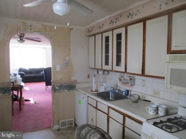 9612 Convent Avenue Philadelphia, PA 19114 - Photo 6 of 33 a kitchen with sink a stove and cabinets