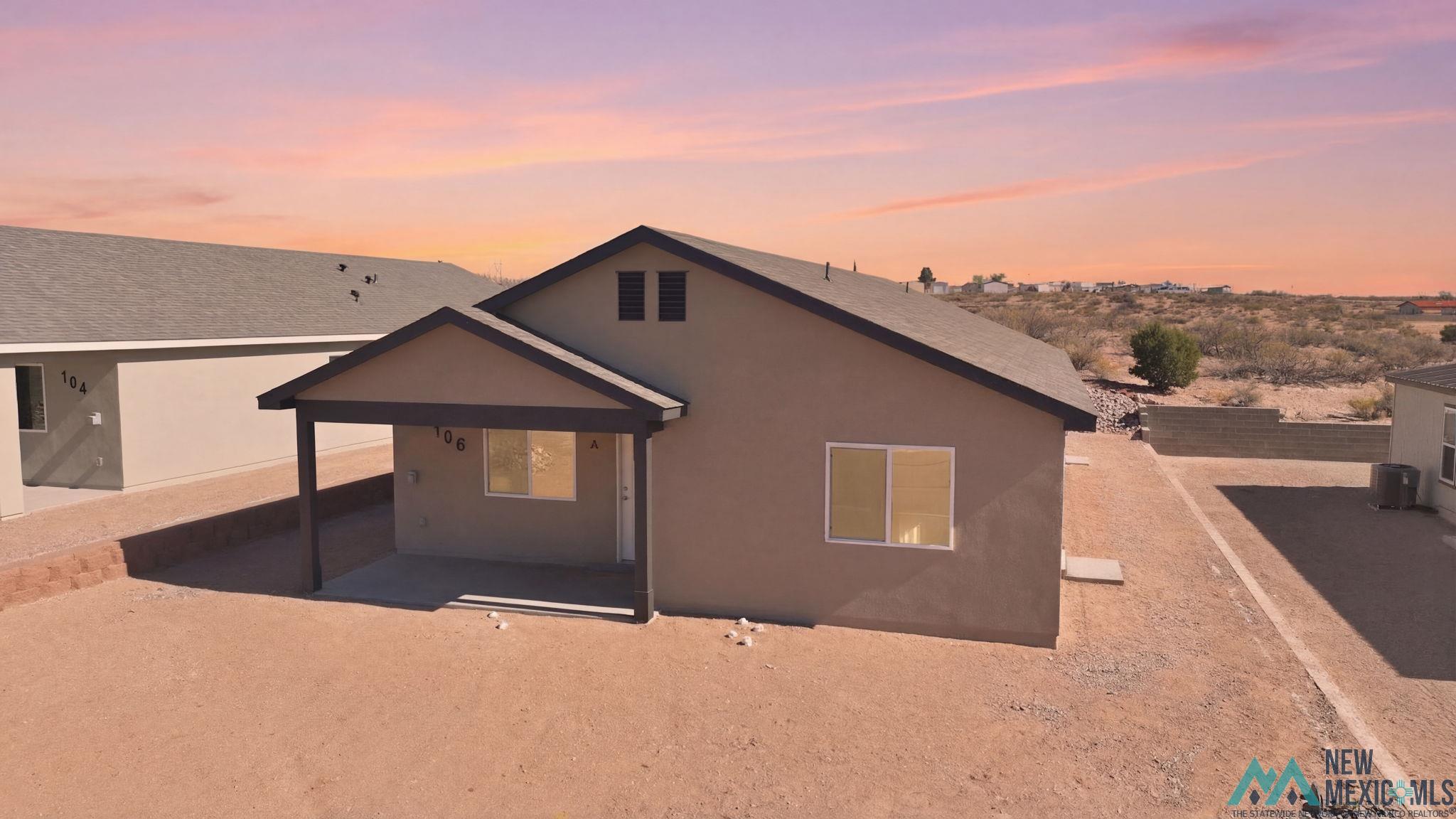 106 Inca Street Elephant Butte, NM 87935 - Photo 35 of 36 Back of property at dusk featuring a patio and stucco siding