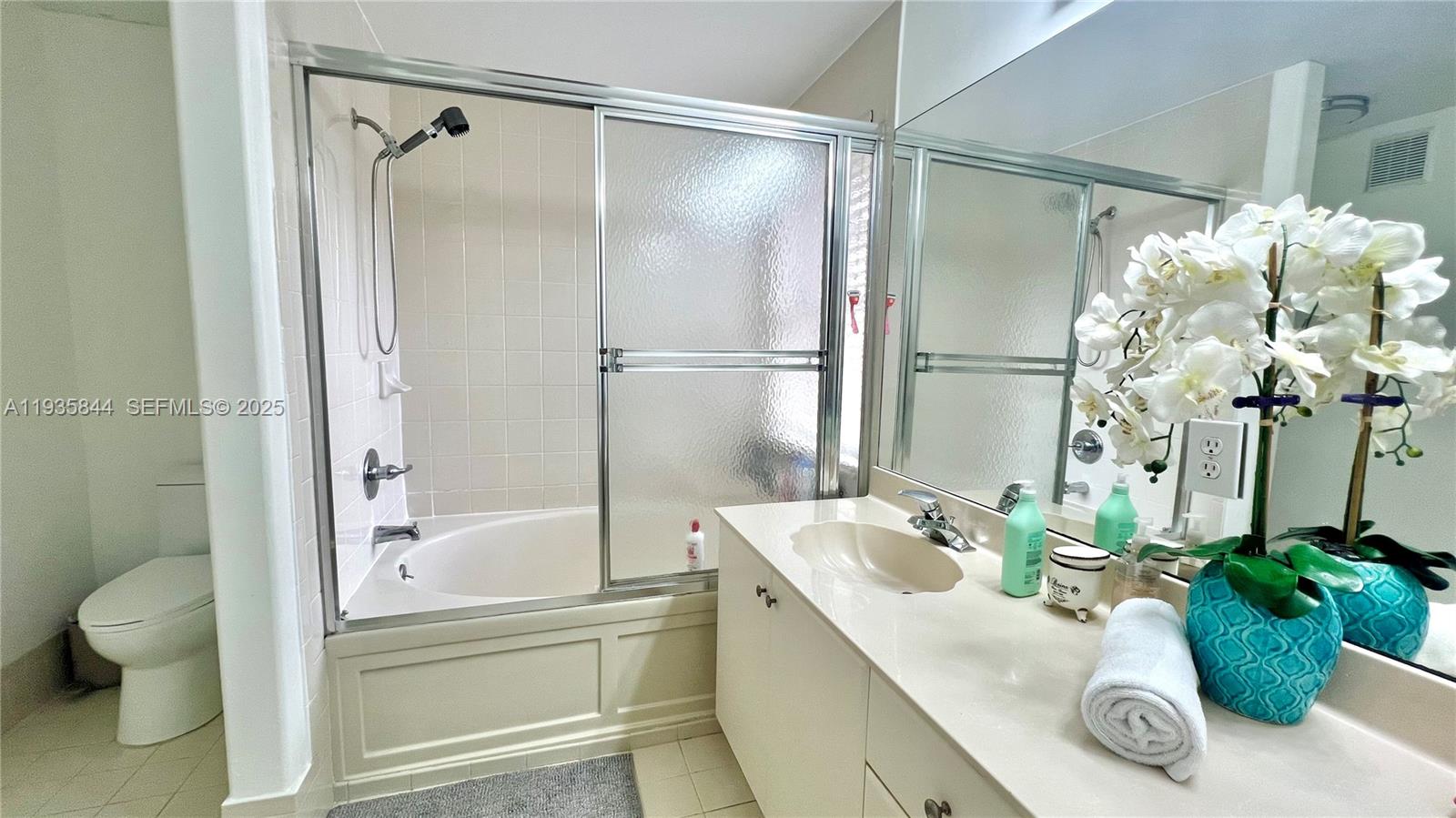 17014 Southwest 39th Street Miramar, FL 33027 - Photo 7 of 11 a bathroom with a granite countertop shower a mirror and a sink