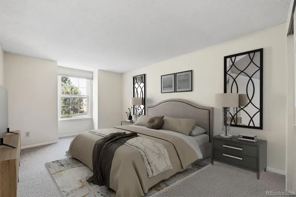 a bedroom with a bed and a night stand