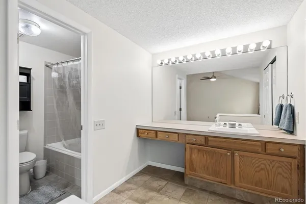 a bathroom with a double vanity sink toilet and shower