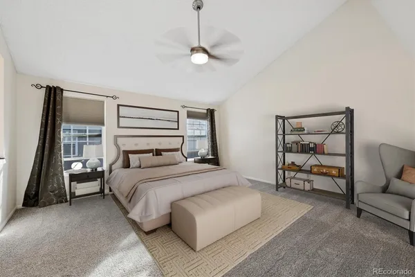 a bedroom with a bed a couch and dresser