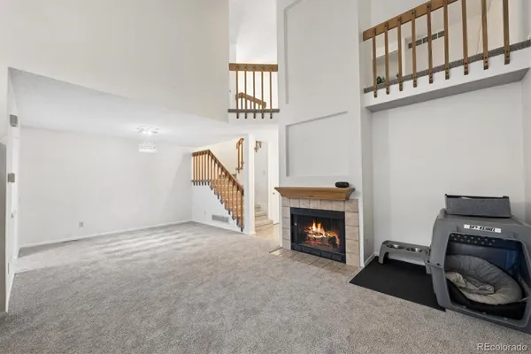 a view of an empty room with furniture and a fireplace