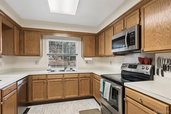 a kitchen with a sink stove top oven and cabinets