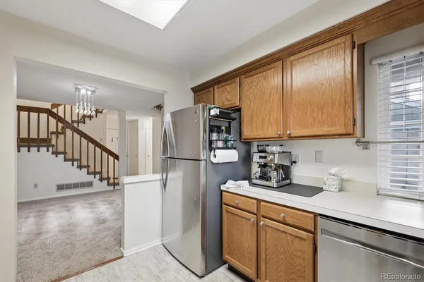a kitchen with stainless steel appliances a refrigerator sink and cabinets