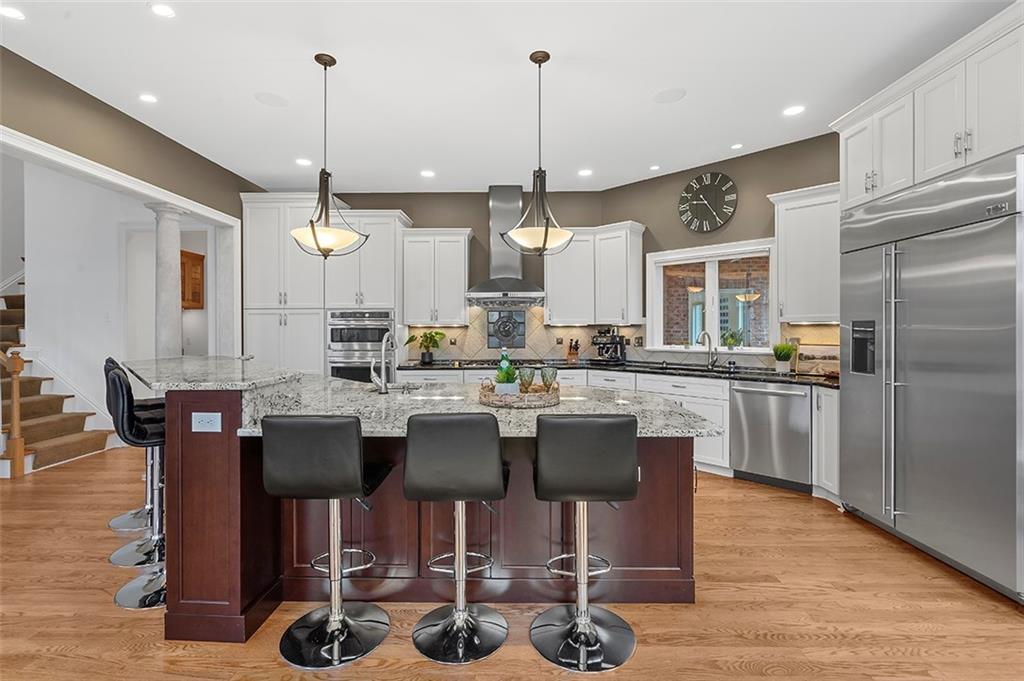 198 Camp Meeting Rd Extension Sewickley, PA 15143 - Photo 17 of 50 a kitchen with a dining table chairs stainless steel appliances and cabinets