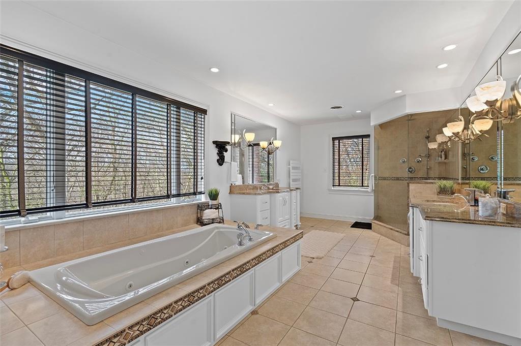 198 Camp Meeting Rd Extension Sewickley, PA 15143 - Photo 23 of 50 a spacious bathroom with a tub a double vanity sink a mirror and a shower