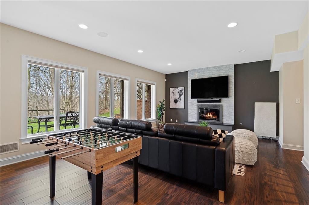 198 Camp Meeting Rd Extension Sewickley, PA 15143 - Photo 32 of 50 a living room with furniture a flat screen tv and a large window