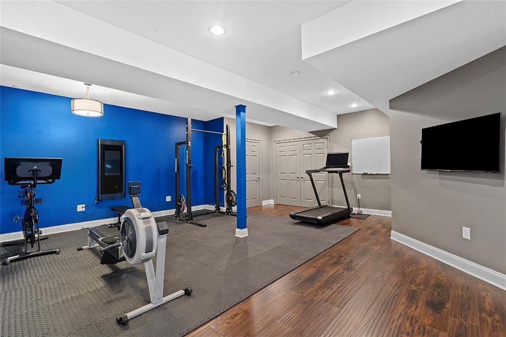 198 Camp Meeting Rd Extension Sewickley, PA 15143 - Photo 37 of 50 a room with gym equipment and a flat screen tv