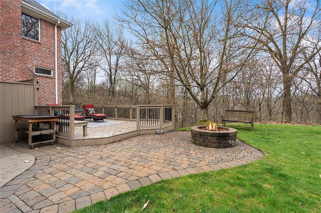 198 Camp Meeting Rd Extension Sewickley, PA 15143 - Photo 45 of 50 a view of a backyard with table and chairs potted plants and large tree