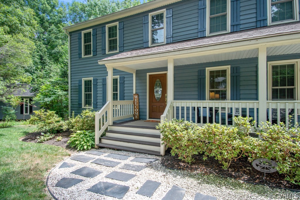 13805 Sterlings Bridge Road Midlothian, VA 23112 - Photo 2 of 24 a view of a house with a small yard and flower plants