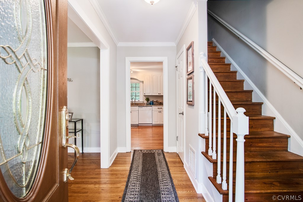 13805 Sterlings Bridge Road Midlothian, VA 23112 - Photo 3 of 24 a view of a hallway with wooden floor and staircase