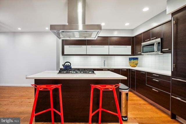 a kitchen with stainless steel appliances granite countertop a stove and a sink