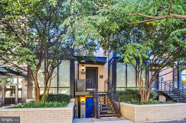 front view of a house with a tree