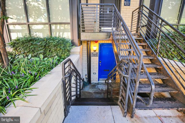a view of building with yard and staircase