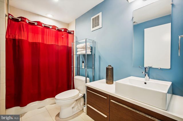 a bathroom with a sink a toilet and shower curtain