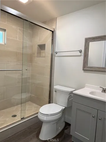 a bathroom with a toilet a sink and shower