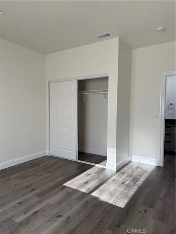 an empty room with wooden floor