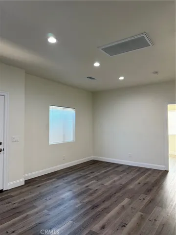 a view of room with wooden floor and window